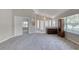 Spacious living area featuring neutral carpet, bright natural light and a glimpse of the entry at 438 Harbour Town Ln, Ormond Beach, FL 32174