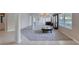 Large living room with neutral color palette, showcasing tiled and carpeted areas at 438 Harbour Town Ln, Ormond Beach, FL 32174