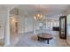 Neutral living space with pillars, elegant chandelier, and access to other rooms at 438 Harbour Town Ln, Ormond Beach, FL 32174
