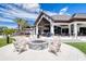 Relaxing outdoor patio with a fire pit and chairs that overlooks the golf course and lake at 438 Harbour Town Ln, Ormond Beach, FL 32174