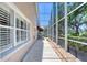 Extended screened patio with awning for outdoor living, surrounded by lush landscaping at 438 Harbour Town Ln, Ormond Beach, FL 32174
