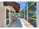 Relaxing patio with comfortable seating, screened enclosure, and awning at 438 Harbour Town Ln, Ormond Beach, FL 32174