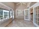 A sunroom with tile floors, white french doors, ceiling fan, and large windows at 438 Harbour Town Ln, Ormond Beach, FL 32174