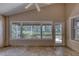 Sunroom with tile floors and large windows offering a view of the outdoor foliage at 438 Harbour Town Ln, Ormond Beach, FL 32174