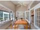 Inviting sunroom with a wooden dining table, chairs, ceiling fan, and bright windows at 438 Harbour Town Ln, Ormond Beach, FL 32174