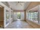 Bright sunroom with tile floor, ceiling fan, and access to the outdoors via sliding glass doors at 438 Harbour Town Ln, Ormond Beach, FL 32174