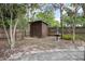 Backyard featuring a shed and fountain, with trees providing ample shade at 45 S University Cir, Deland, FL 32724