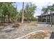 Backyard featuring a fire pit, screened-in porch and a stone paver walkway at 45 S University Cir, Deland, FL 32724