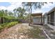 Backyard featuring a pergola, privacy fence and a stone paver walkway at 45 S University Cir, Deland, FL 32724