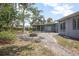 Backyard featuring a fire pit, screened-in porch and a stone paver walkway at 45 S University Cir, Deland, FL 32724