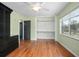 Well-lit bedroom with hardwood floors, ceiling fan, closet and two large windows at 45 S University Cir, Deland, FL 32724