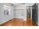 Bedroom featuring hardwood floors, open closet, and large windows that provide ample natural light at 45 S University Cir, Deland, FL 32724