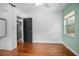 Bright bedroom with wood floors, ceiling fan and light colored walls and black door at 45 S University Cir, Deland, FL 32724