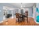 Open dining room with hardwood floors, open to the living room with lots of natural light at 45 S University Cir, Deland, FL 32724