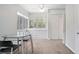 Bright dining area featuring a glass table set, built-in storage, and multiple windows for ample natural light at 45 S University Cir, Deland, FL 32724