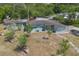 Charming, one-story blue home featuring mature landscaping and a unique decorative carport screen at 45 S University Cir, Deland, FL 32724