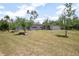 Charming single-story home with mature landscaping and a bright red front door at 45 S University Cir, Deland, FL 32724