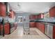 Spacious kitchen features stainless steel appliances, tile flooring and dark wood cabinets at 45 S University Cir, Deland, FL 32724