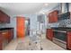 Kitchen with stainless appliances, tile floors, and access to other living spaces at 45 S University Cir, Deland, FL 32724