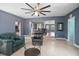 Comfortable living room featuring modern ceiling fan, neutral flooring, and plenty of natural light at 45 S University Cir, Deland, FL 32724