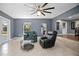 Bright living room features neutral tile flooring, leather chairs and lots of natural light at 45 S University Cir, Deland, FL 32724
