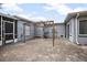 Outdoor patio with gray brick pavers and an overhead trellis and view of the backyard at 45 S University Cir, Deland, FL 32724