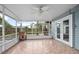 Spacious screened-in patio featuring tile flooring, ceiling fan and views of the backyard at 45 S University Cir, Deland, FL 32724