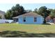 Spacious backyard featuring a well-maintained lawn and a patio area with outdoor furniture at 4611 Se 32Nd Pl, Ocala, FL 34480