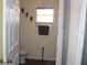Simple bathroom featuring neutral walls, wood floors, and a decorative towel rack and window blind at 4611 Se 32Nd Pl, Ocala, FL 34480