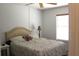 Bright bedroom featuring a ceiling fan and light, neutral walls, and a window with blinds at 4611 Se 32Nd Pl, Ocala, FL 34480