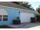 Exterior of the two car garage featuring white door and light blue exterior walls at 4611 Se 32Nd Pl, Ocala, FL 34480