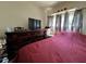 Bedroom boasts wood dresser and curtains that let in natural light at 487 Collins St, Ormond Beach, FL 32174