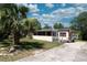 Charming home with a palm tree, large windows, and well maintained lawn at 487 Collins St, Ormond Beach, FL 32174