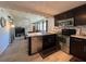 Well-equipped kitchen with stainless steel appliances, dark cabinetry, and open layout to living area at 487 Collins St, Ormond Beach, FL 32174
