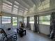 Bright sunroom featuring large windows, neutral flooring, and ample space for relaxation and enjoying the view at 487 Collins St, Ormond Beach, FL 32174