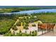 Expansive aerial view of a sprawling estate, showcasing the house and extensive property with equestrian barn at 5366 N Lake Farms Rd, De Leon Springs, FL 32130