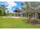 Expansive backyard featuring a stone patio with a fire pit and ample seating, great for outdoor gatherings at 5366 N Lake Farms Rd, De Leon Springs, FL 32130