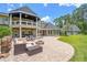 Large backyard patio with a fire pit and ample seating, perfect for outdoor gatherings and relaxing at 5366 N Lake Farms Rd, De Leon Springs, FL 32130