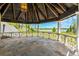 Spacious balcony with decorative railings offering stunning views of the lake and surrounding greenery at 5366 N Lake Farms Rd, De Leon Springs, FL 32130