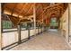 Well-maintained barn interior featuring a brick aisle and wooden stalls at 5366 N Lake Farms Rd, De Leon Springs, FL 32130