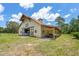 Barn with cupola, stalls, and covered area for storage, set in a grassy pasture at 5366 N Lake Farms Rd, De Leon Springs, FL 32130