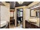 Elegant bathroom featuring dual vanities, granite countertops, and decorative mirrors at 5366 N Lake Farms Rd, De Leon Springs, FL 32130