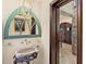 Unique bathroom features a custom stone sink and detailed mirror with intricate woodwork at 5366 N Lake Farms Rd, De Leon Springs, FL 32130