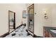 Hallway view of the charming bathroom with a walk-in shower, toilet, and vanity at 5366 N Lake Farms Rd, De Leon Springs, FL 32130