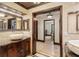 The spacious bathroom features tiled floors, granite counters, and unique stone sinks at 5366 N Lake Farms Rd, De Leon Springs, FL 32130