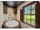 Bathroom with a soaking tub, detailed fountain, and a beautiful view at 5366 N Lake Farms Rd, De Leon Springs, FL 32130