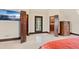 Bedroom with a flatscreen TV, french doors and built-in shelving at 5366 N Lake Farms Rd, De Leon Springs, FL 32130