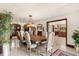 Large formal dining room with a wood table, upholstered chairs, and elegant light fixture at 5366 N Lake Farms Rd, De Leon Springs, FL 32130