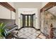Grand entryway with stone accent wall, piano and tiled flooring at 5366 N Lake Farms Rd, De Leon Springs, FL 32130
