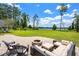 Inviting stone patio with a cozy fire pit and comfortable outdoor seating, perfect for relaxation at 5366 N Lake Farms Rd, De Leon Springs, FL 32130